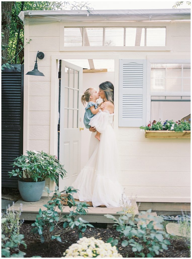 Mother Holds Her Daughter In A Door Way And They Nose Nuzzle