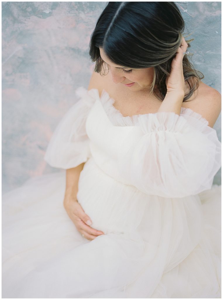 Pregnant Mother Moves Her Hair Out Of Her Face For Her Studio Session