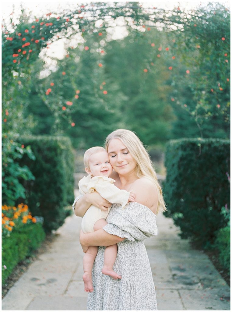 Mother Holds Her Smiling Baby Close To Her And Closes Her Eyes