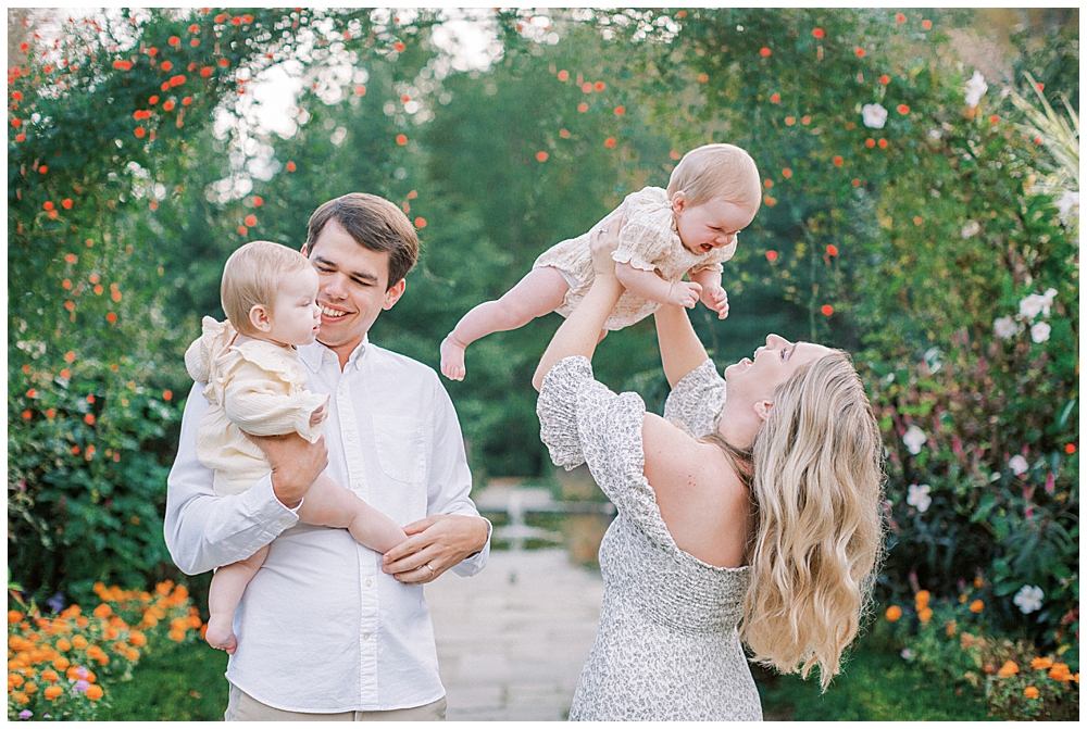 Mother And Father Hold Their Twin Babies Up