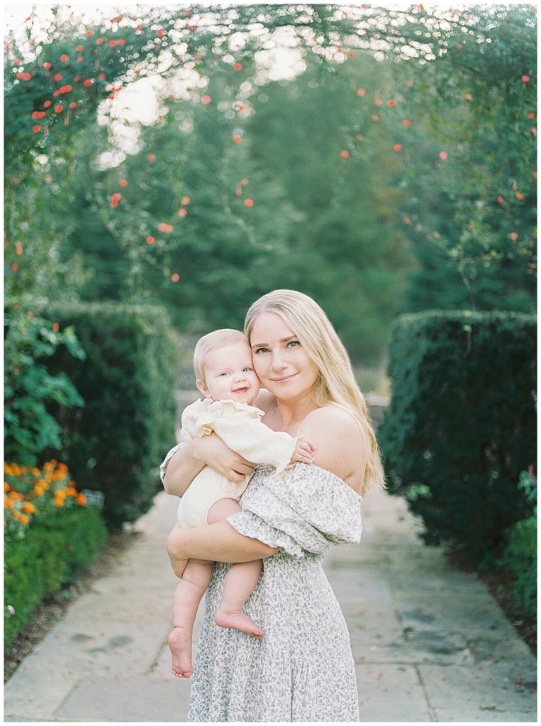 Mother holding her baby in Brookside Gardens during their DC family photo session