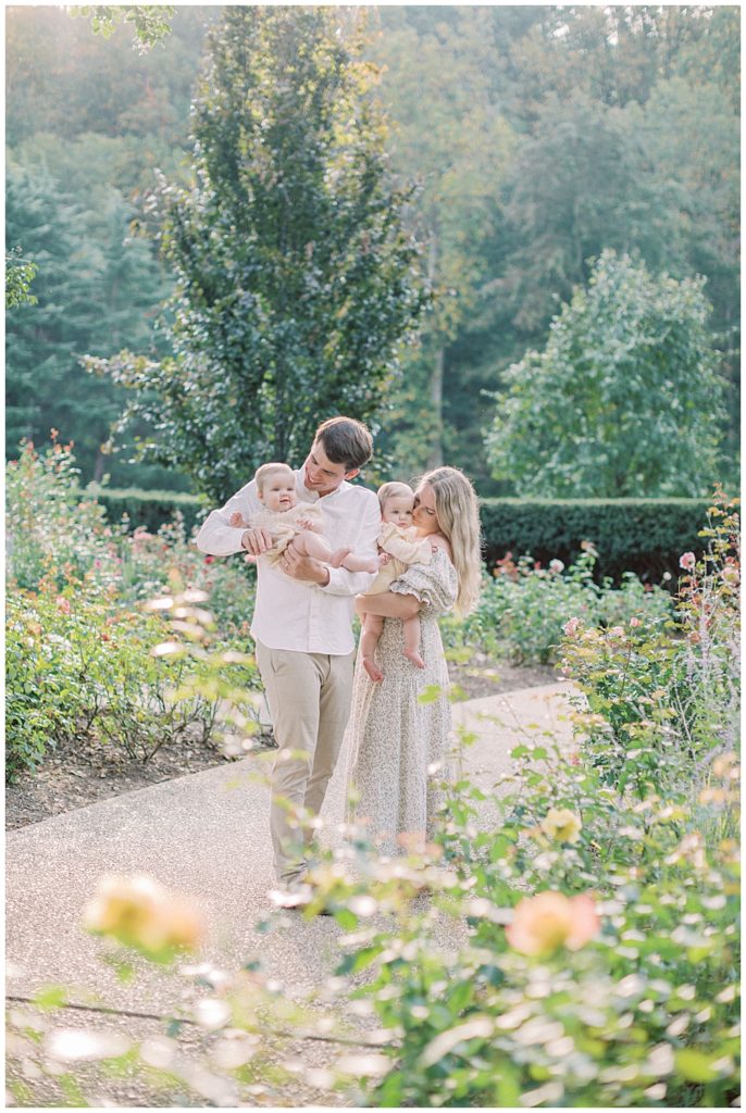 Parents Holding Their Twin Babies In Brookside Gardens Outside Of Washington Dc