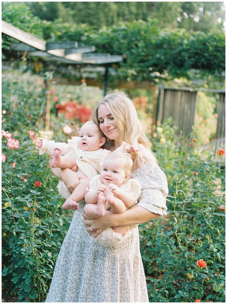 Mother Holding Her Twin Baby Girls, Resting Her Head On Theirs