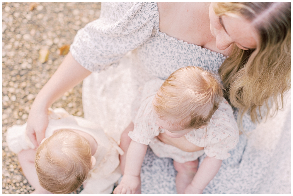 Mother Caresses Her Two Twin Baby Girls