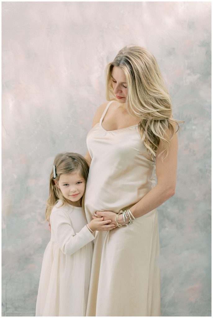 Mother Looks Down At Her Little Girl While Embracing