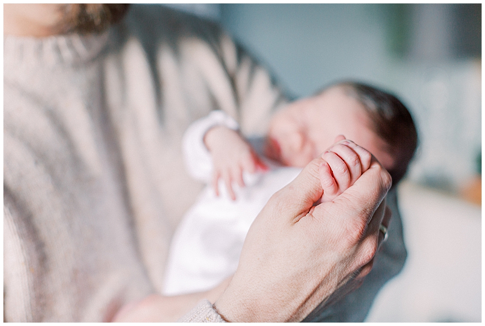 A Father Holds His Newborn Daughter's Hand