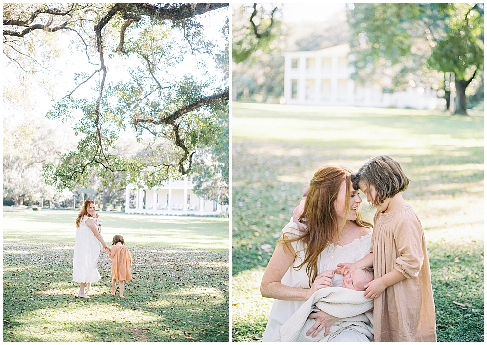 A Mother And Her Young Daughter With Their Newborn Baby Walk Together And Then Kneel Towards One Another During Their Newborn Session