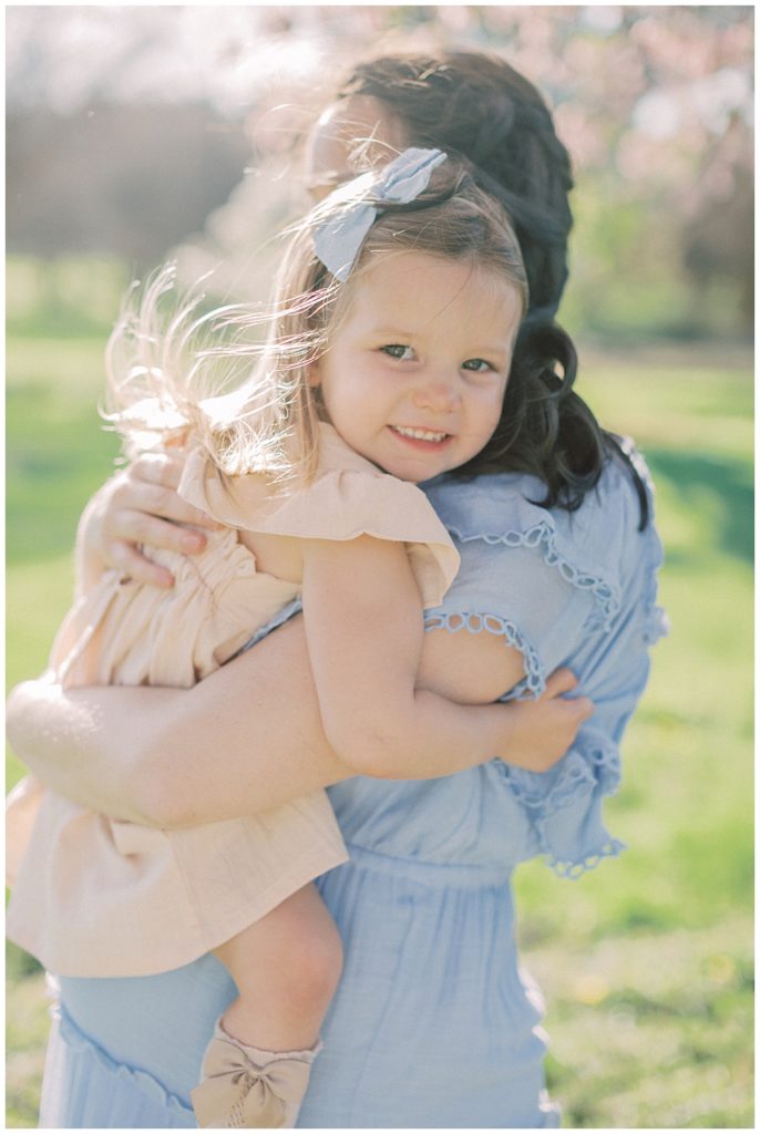 A Pregnant Mother Holds Her Toddler Daughter 