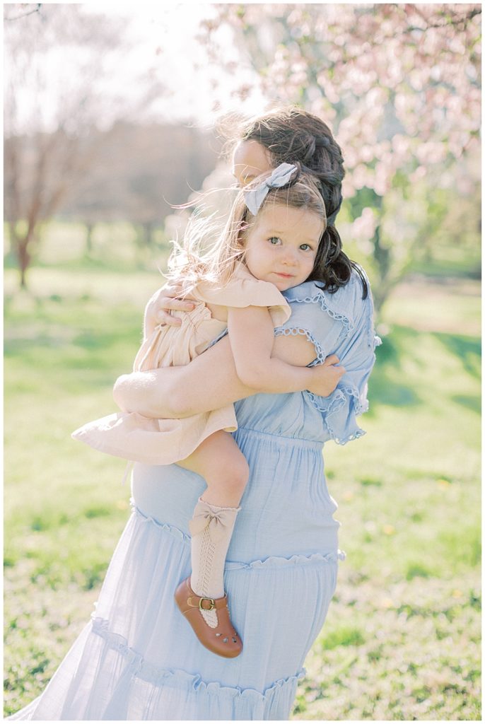 Pregnant Mom Holds Her Toddler Daughter