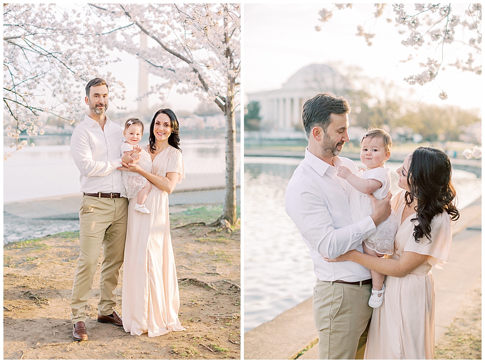 A Mother And Father Hold Their Infant Daughter By The Cherry Blossom Trees Along The Tidal Basin At Sunrise