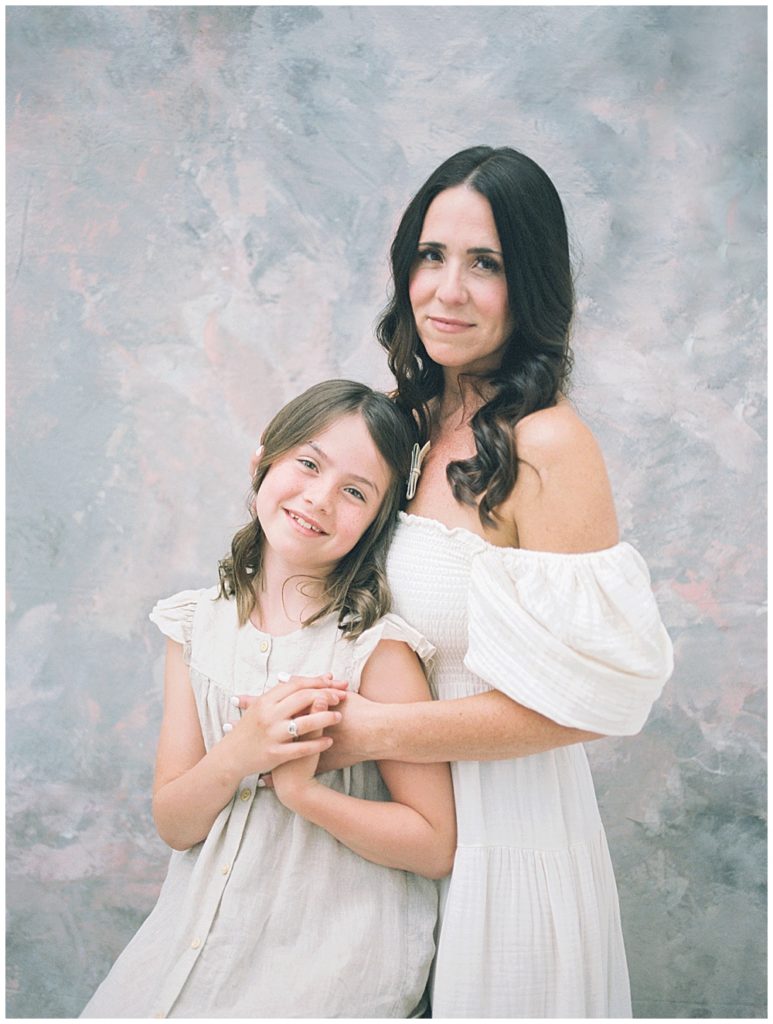 A Mother Stands With Her Daughter During Their Mama And Me Session