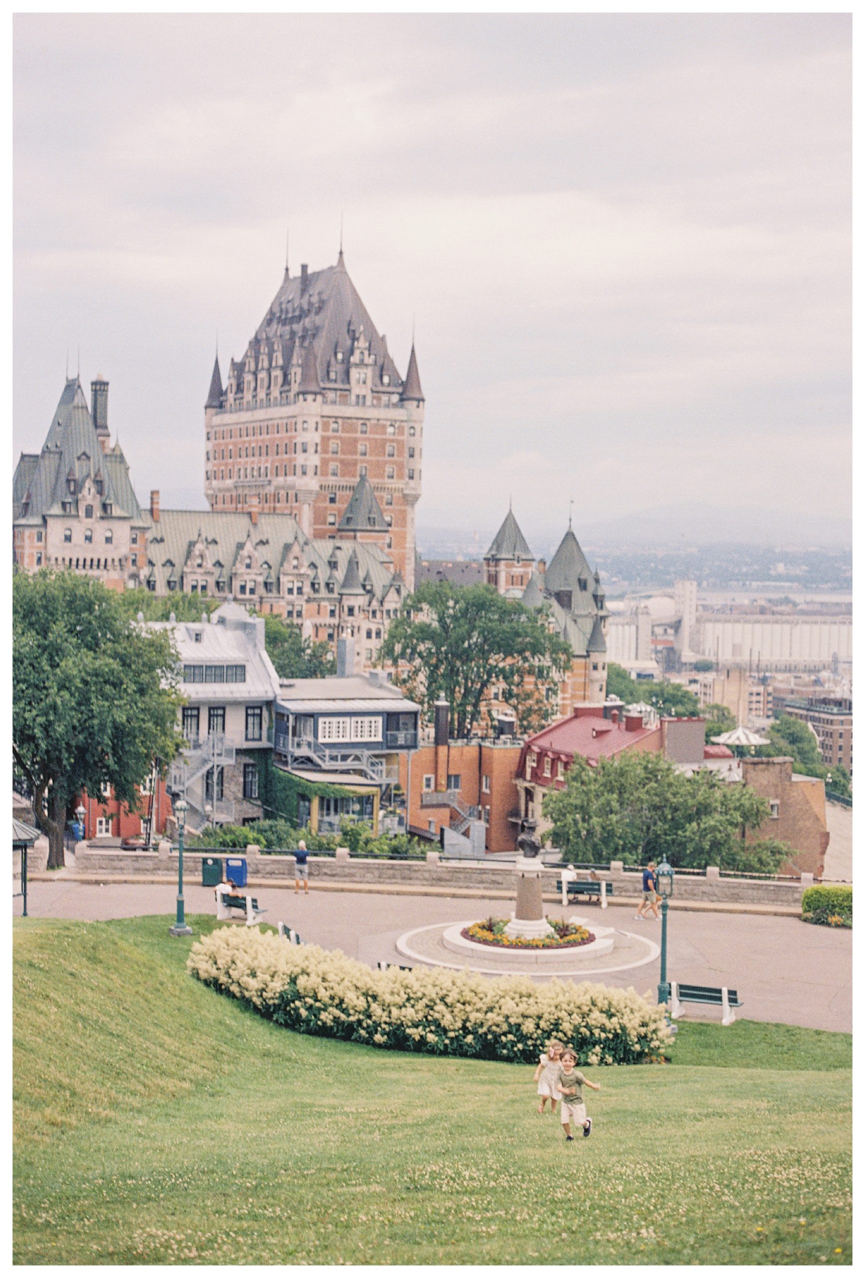 Children Run Up Grassy Hill In Quebec City.