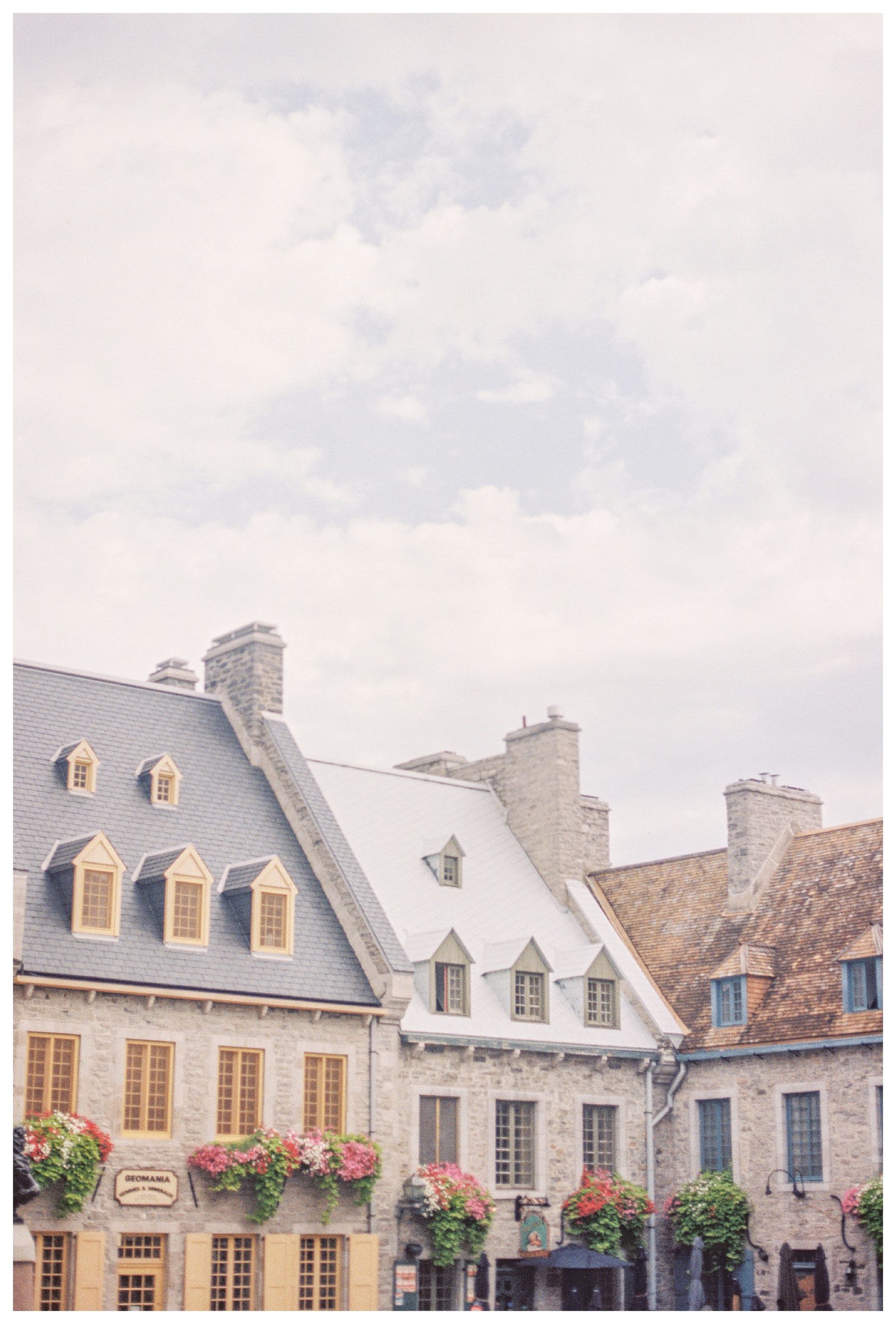 Roofs Of Stone Buildings With Floral Window Boxes In Quebec City