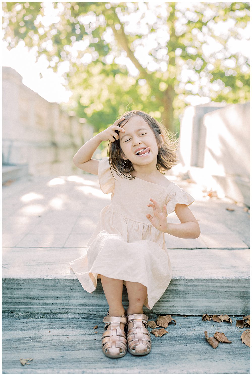 Little Girl Sits On Steps Of Dar Constitution Hall And Makes A Silly Face.