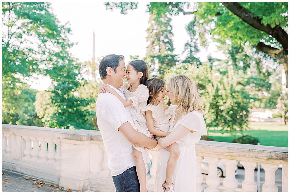 Parents Hold Their Two Young Girls As They Stand At The Dar Constitution Hall For Family Photos.