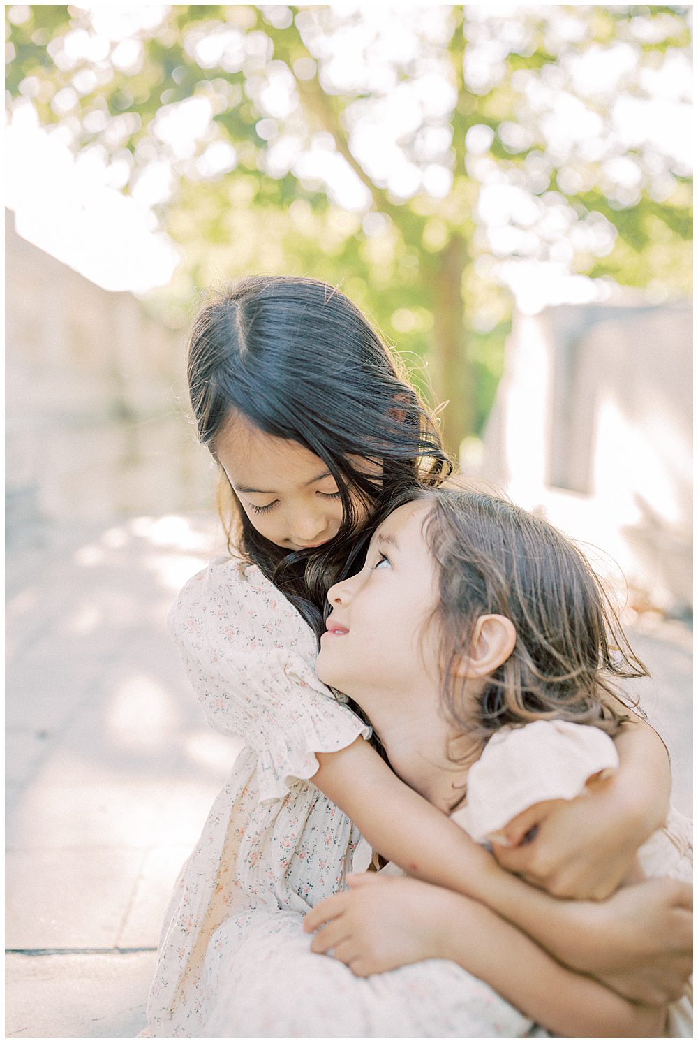 Big Sister Holds Her Younger Sister As They Sit On The Steps Of The Dar Constitution Hall.