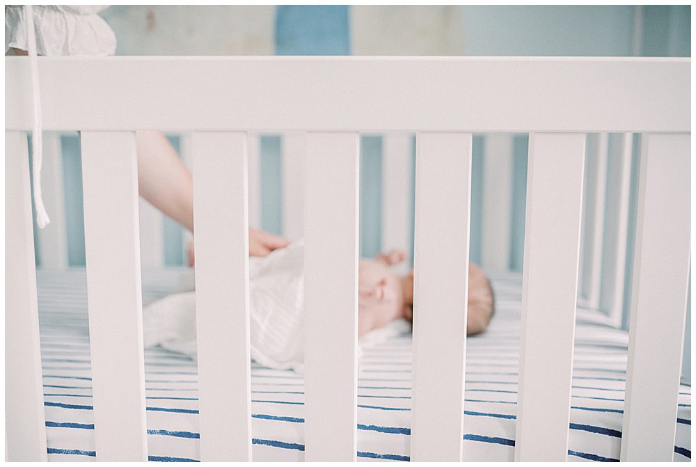 Baby Boy Lays In His Crib