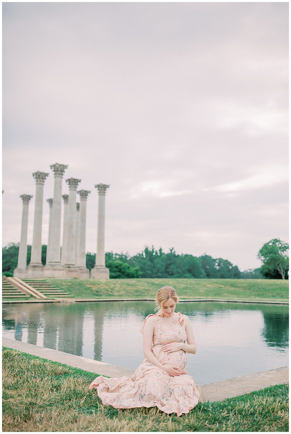 Pregnant Mother Sits, Admiring Her Belly, In Front Of Pond At The National Arboretum.