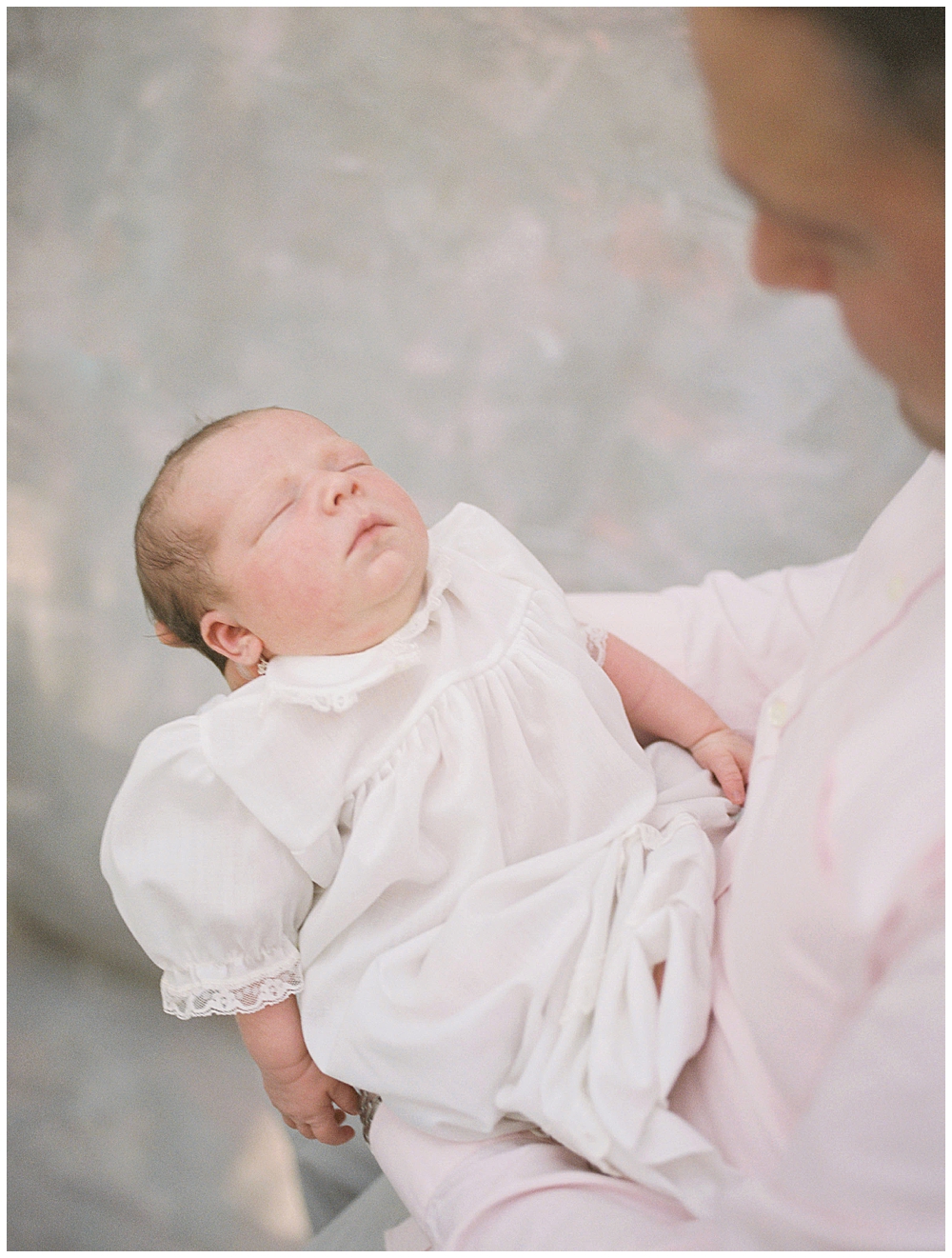 View Of Newborn Baby Held By Her Father