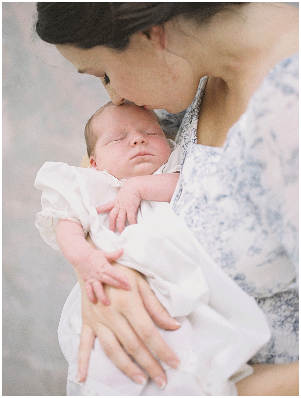 Mom Kisses Her Newborn's Head