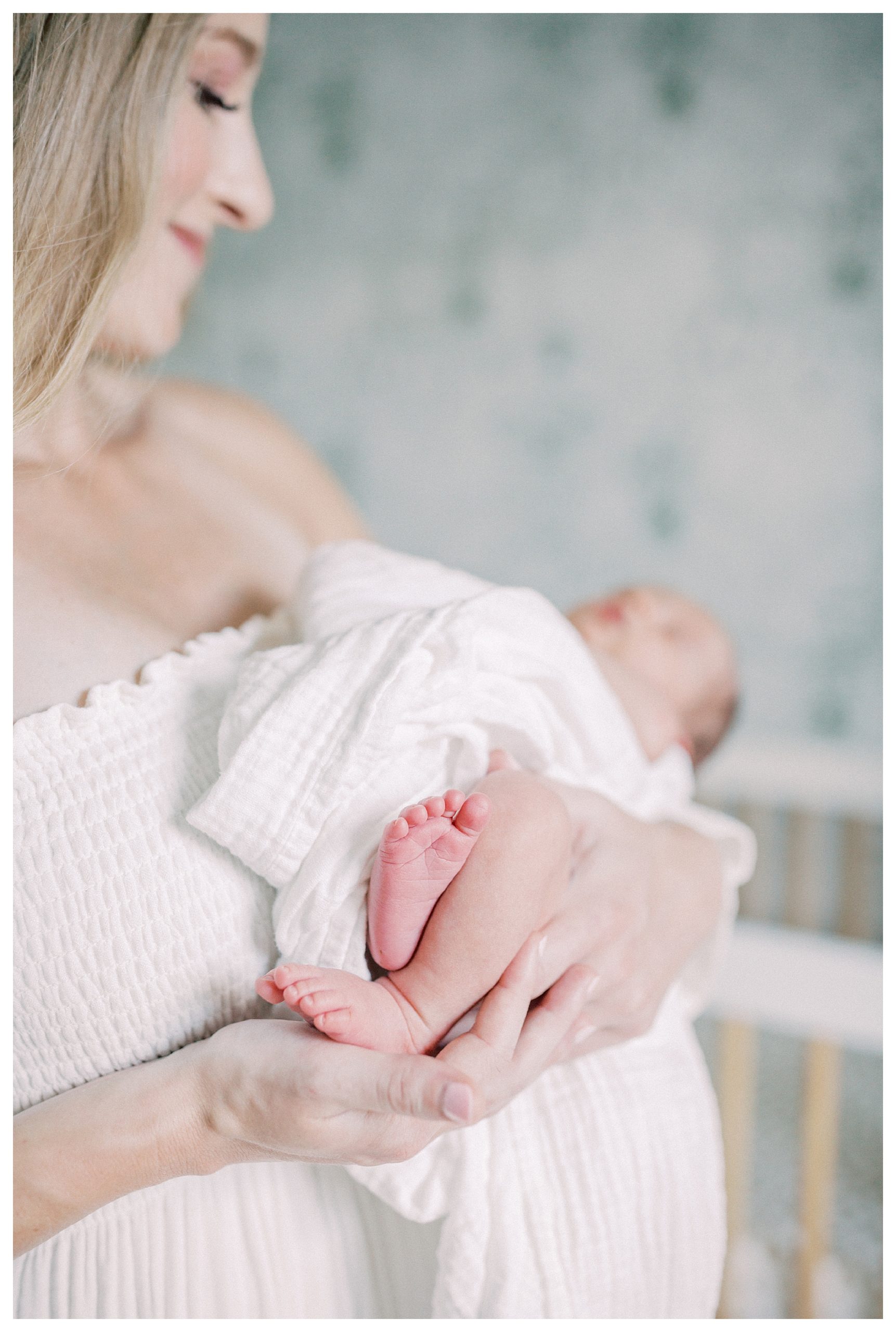 Baby Feet Held Up By Mother During A Dc Newborn Session In Capital Hill.