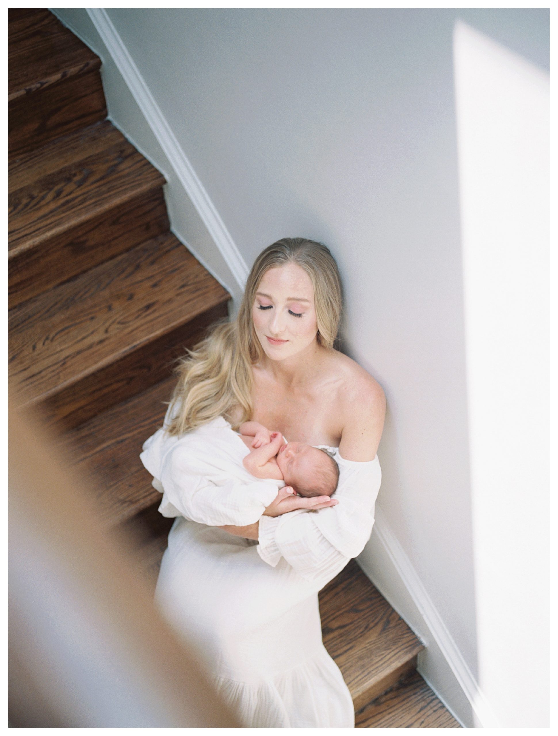 Mother Sits On Steps Holding Newborn Baby During Dc Newborn Session On Capital Hill.