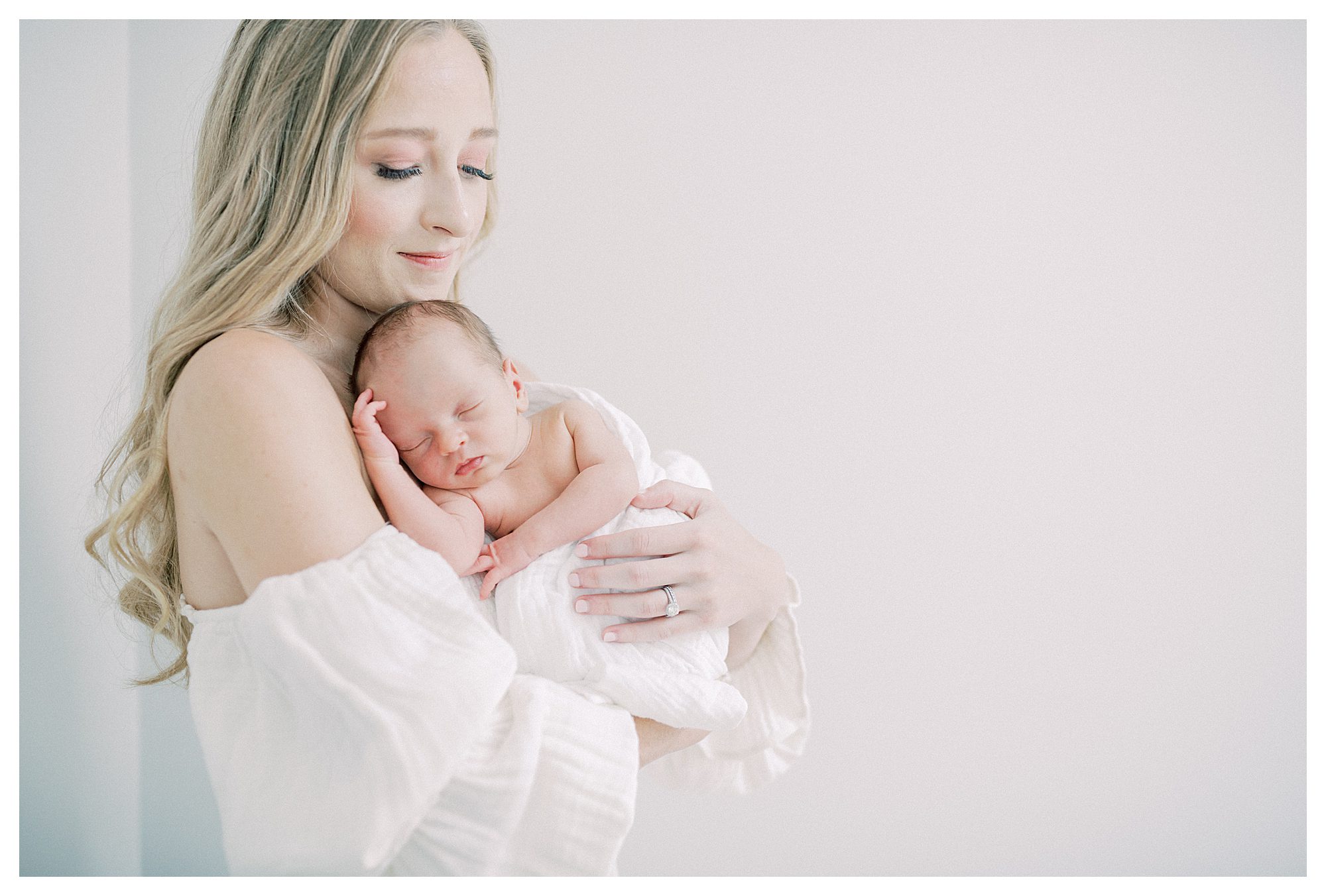 Blonde New Mother Holds Infant Baby Up To Her Chest During Dc Newborn Session.