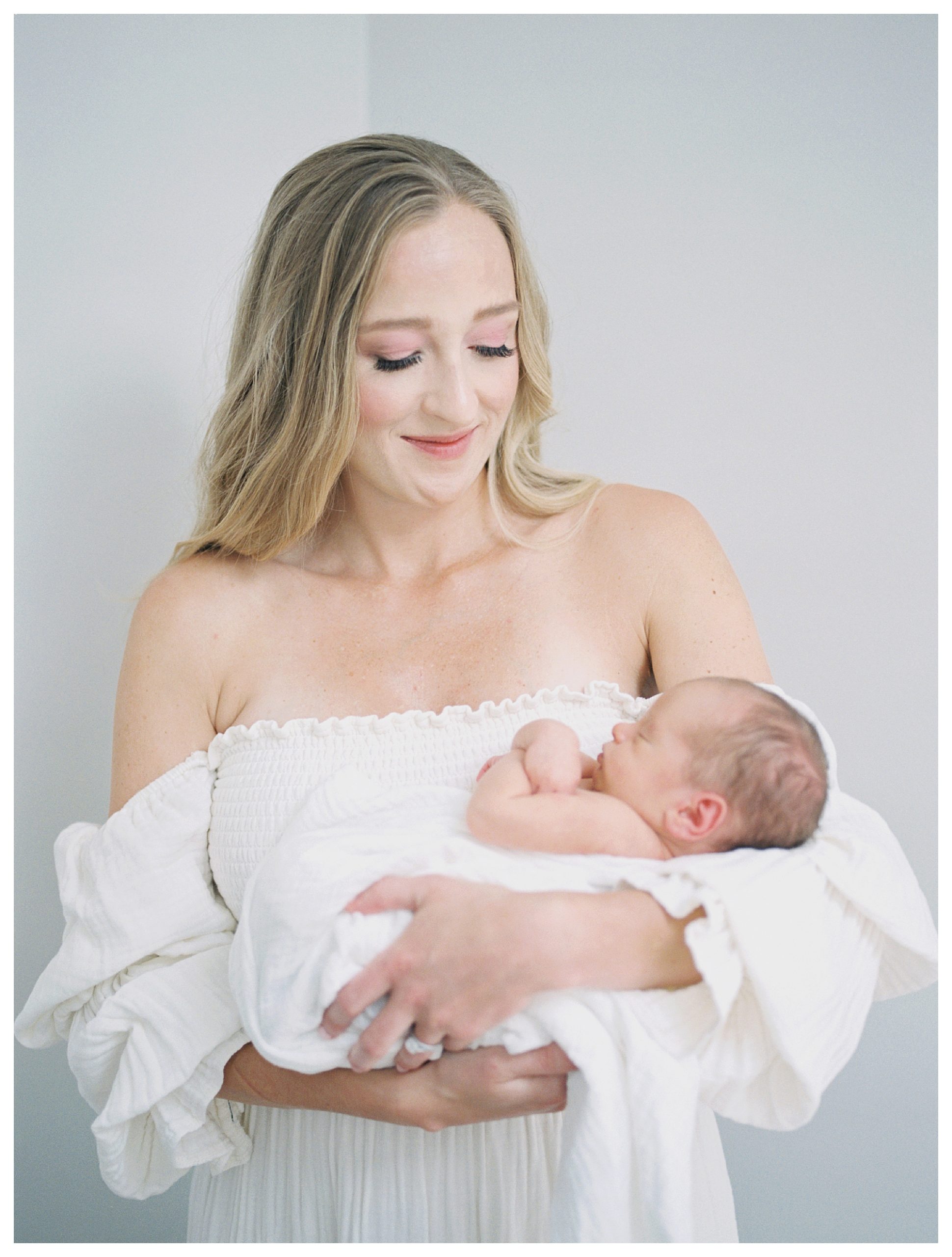 Blonde Mother Holds Her Newborn Baby Boy During Her Dc Newborn Session On Capital Hill.