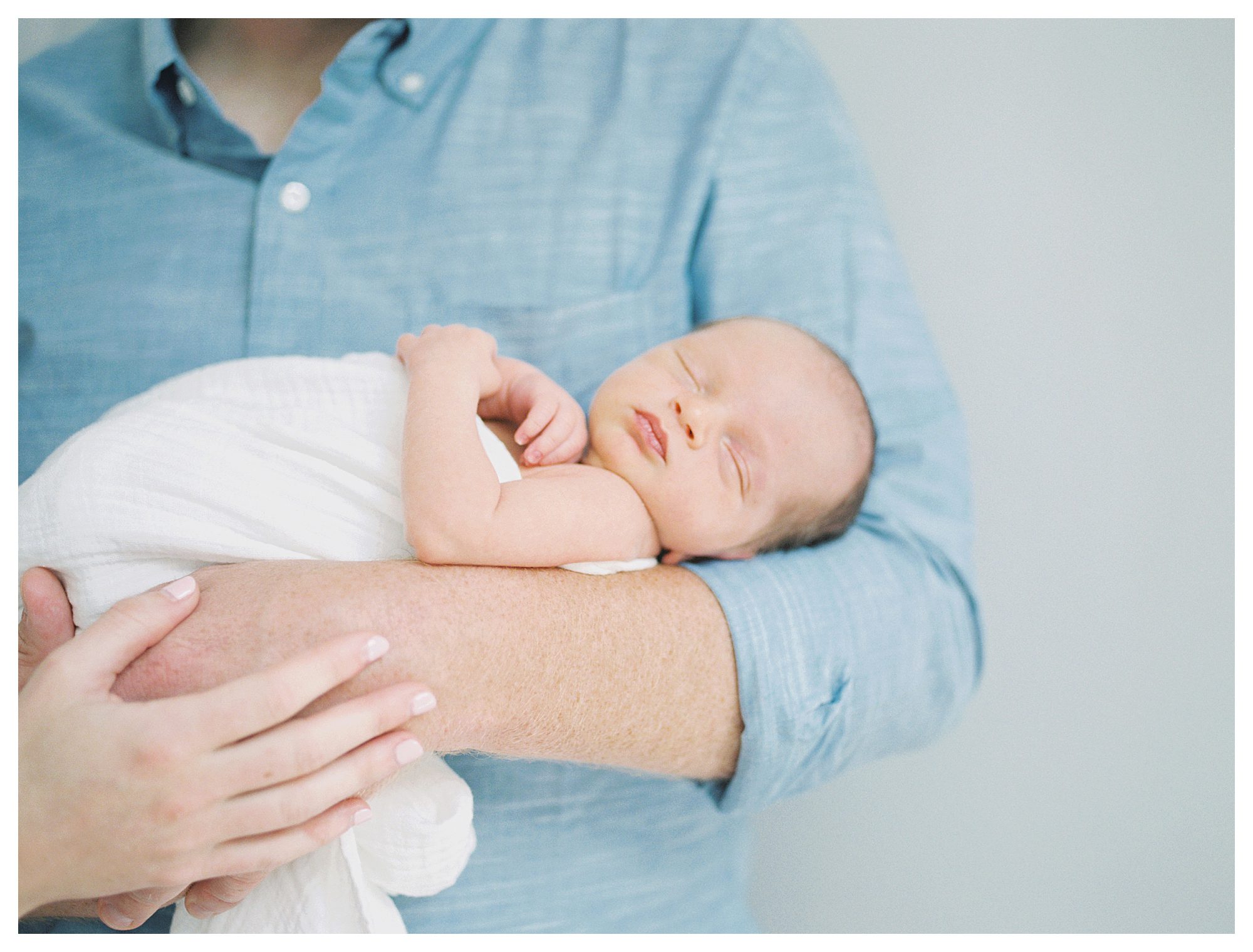 Newborn Baby Held By His Father During Dc Newborn Session.