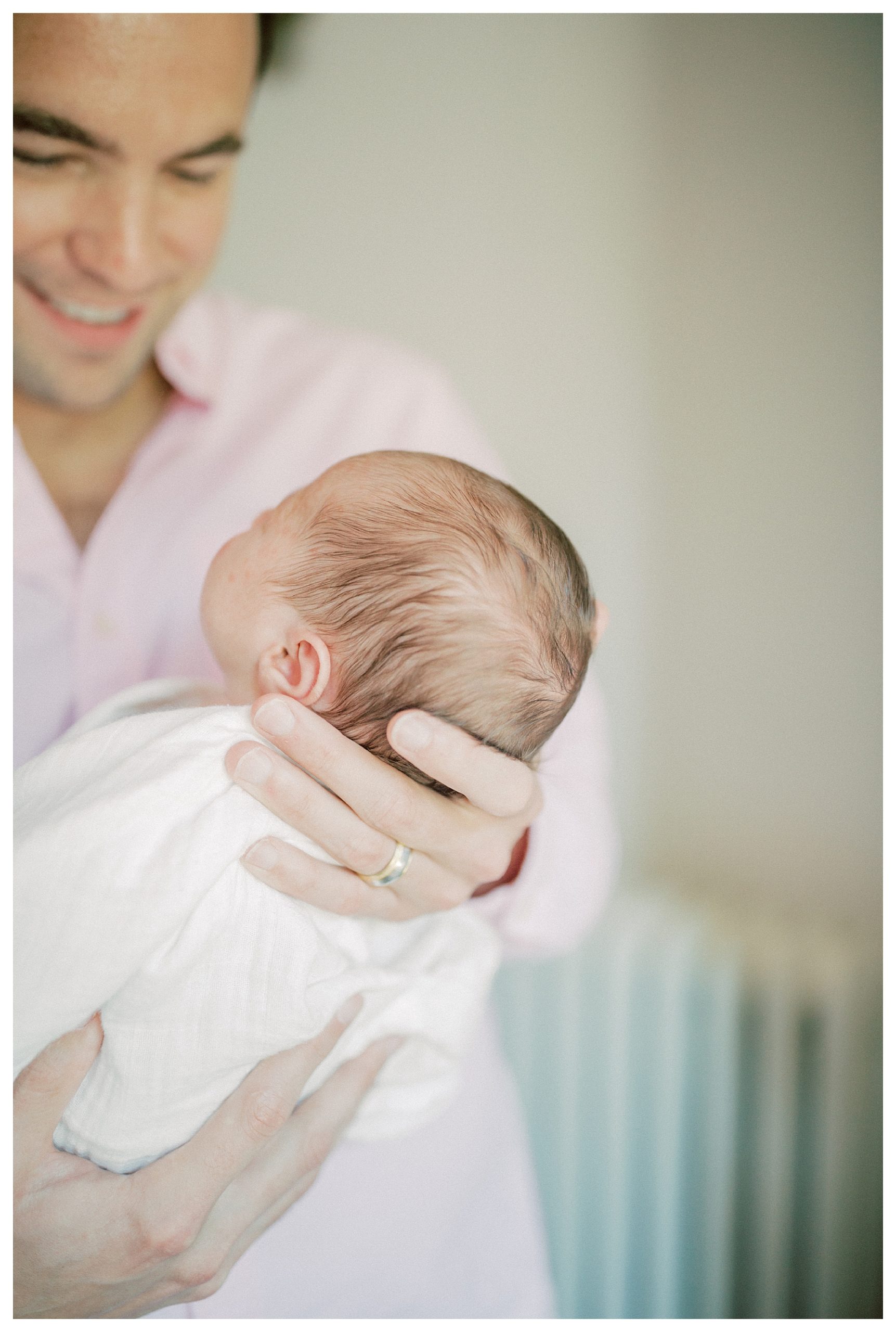 Father Holds Baby In Front Of Him So Head And Hair And Close Up