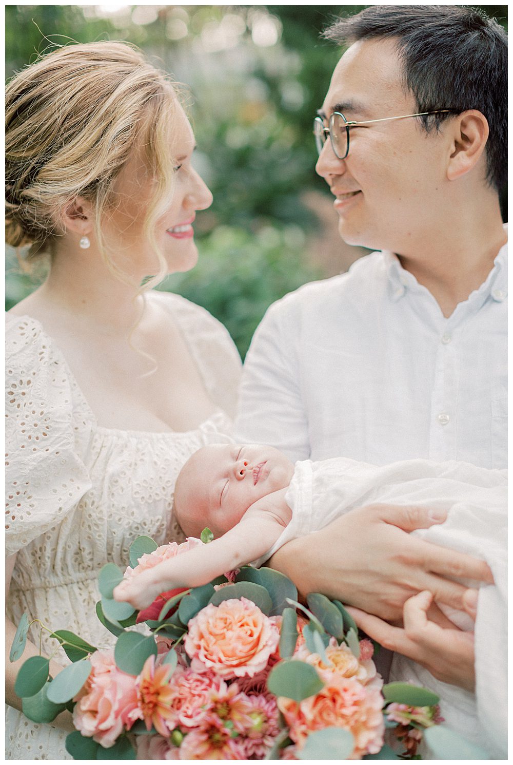 Parents Smile While Holding Their Newborn Daughter.