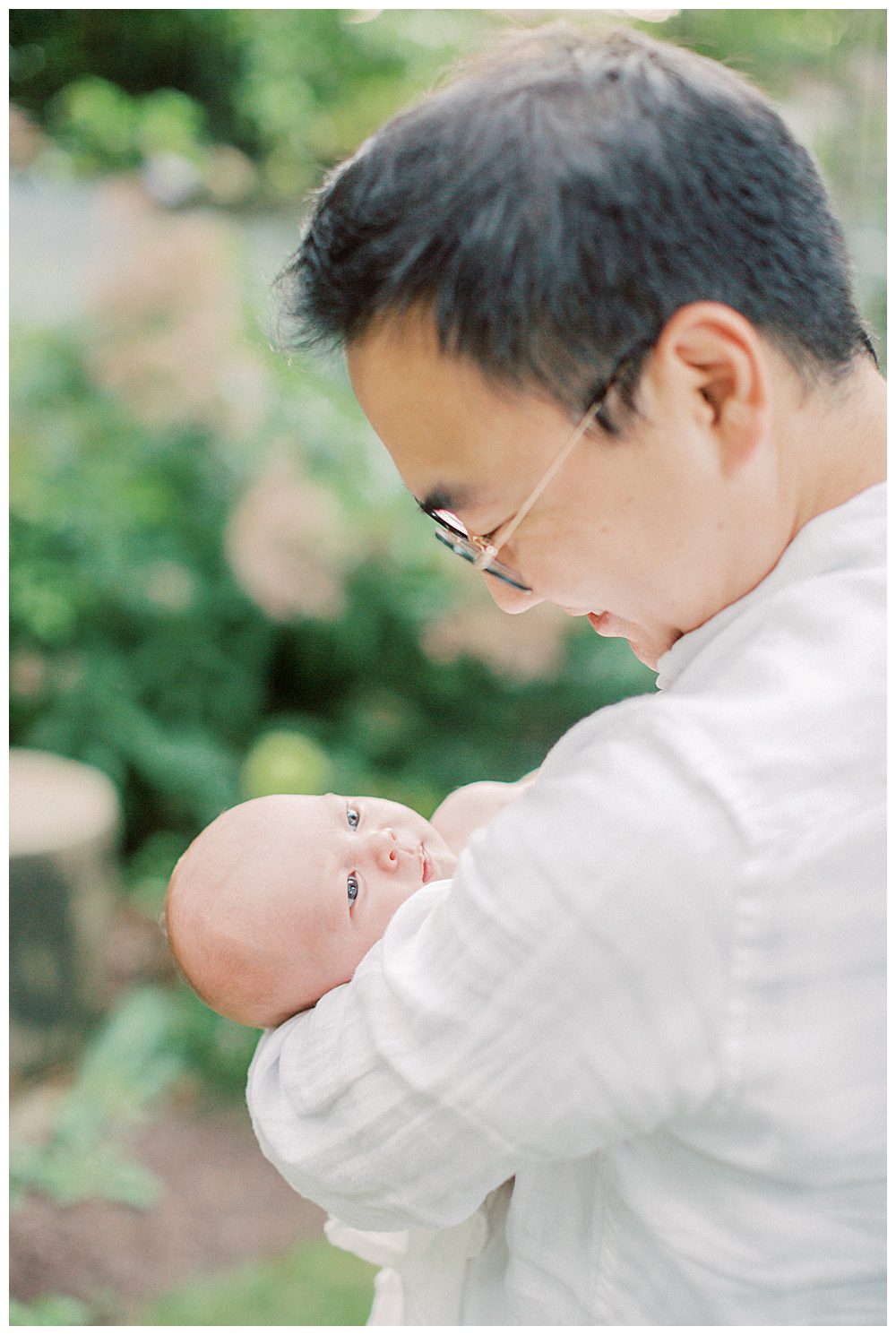 Newborn Baby Looks Up At Her Father During Alexandria Va Newborn Session.