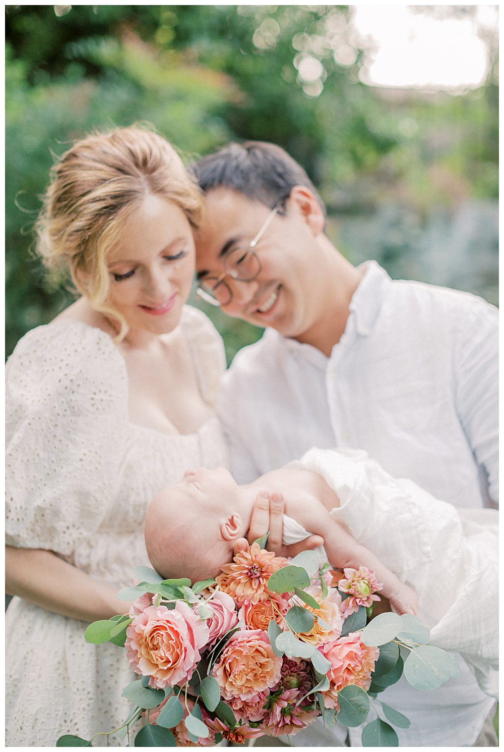 Father Holds Newborn Baby And Leans Into Mother Holding Roses During Alexandria Va Newborn Session.