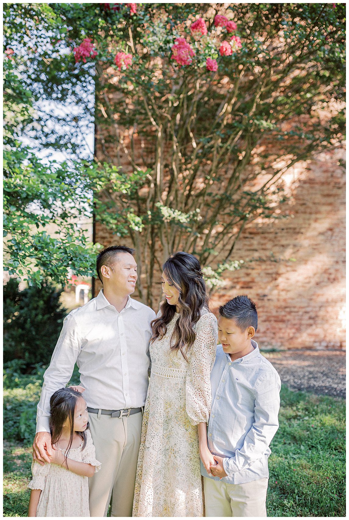 Mother And Father Stand With Their Son And Daughter At Colvin Run Mill In Front Of A Crepe Myrtle.