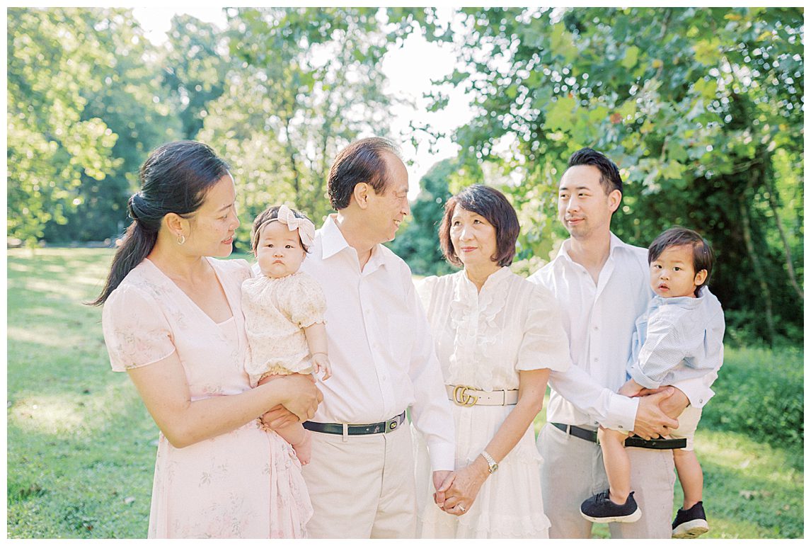 Grandmother And Grandfather Look At Each Other While Standing With Their Family At Colvin Run Mill.