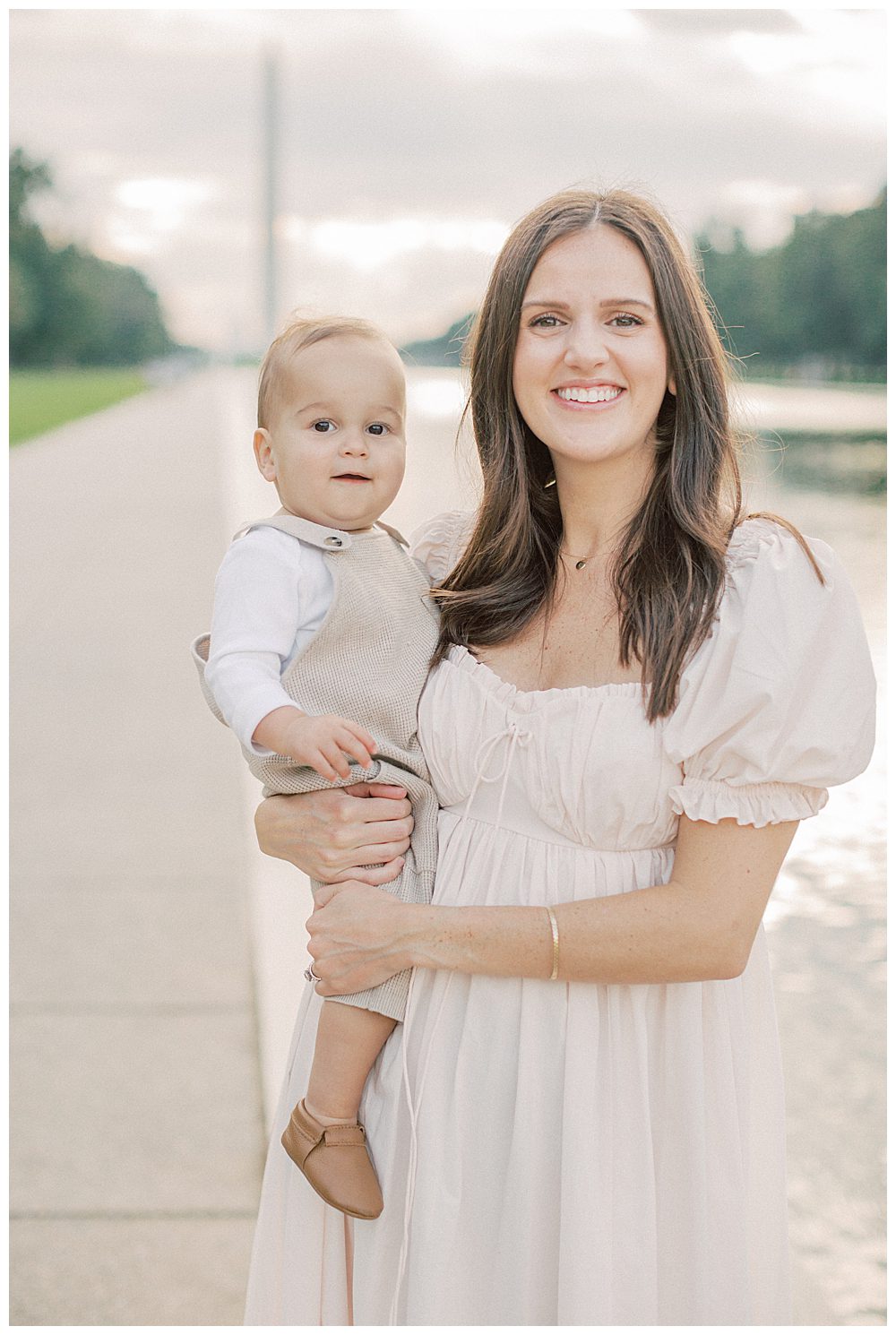 Mother In Pink Selkie Dress Holds Toddler Son By Dc Reflecting Pool.