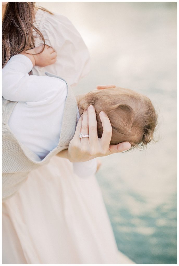 Mother Cradles Son's Head With Her Hand.