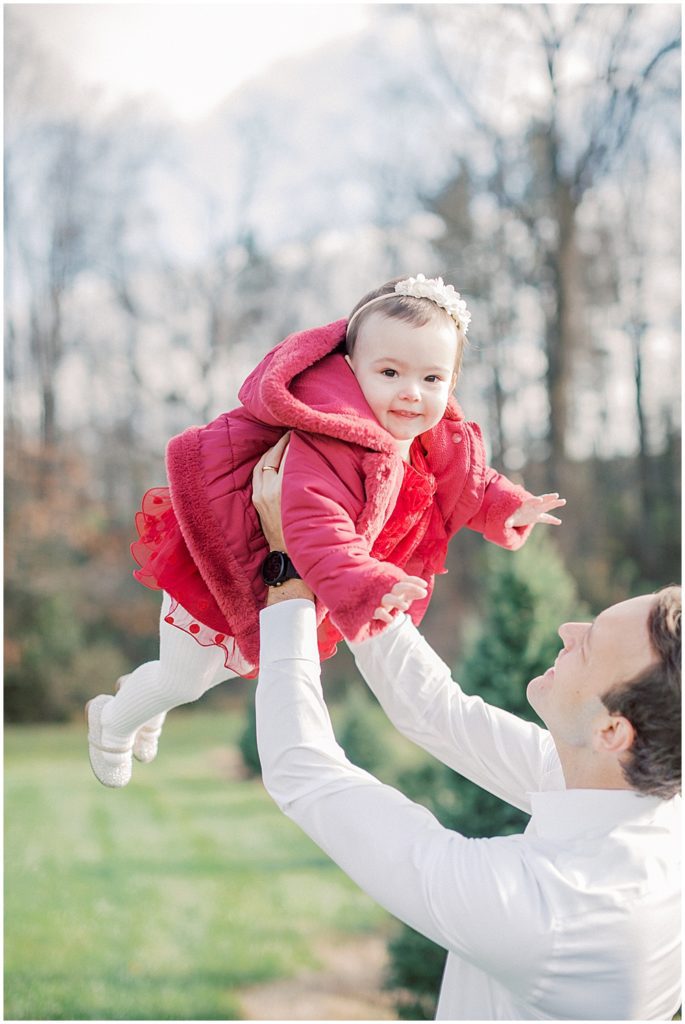 Little Girl Held Up In Air By Her Father.