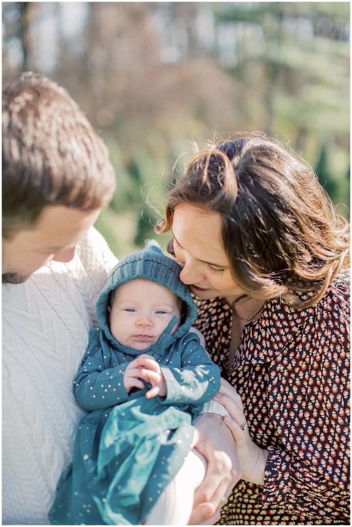 Mother Kisses Daughter's Head During Christmas Mini Sessions At Butler's Orchard