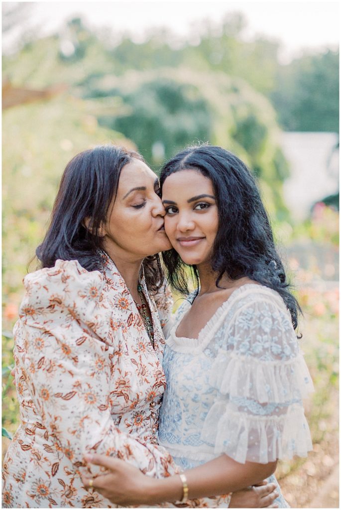 Mother Kisses Her Daughter On The Cheek During Their Family Photo Session At Brookside Gardens.