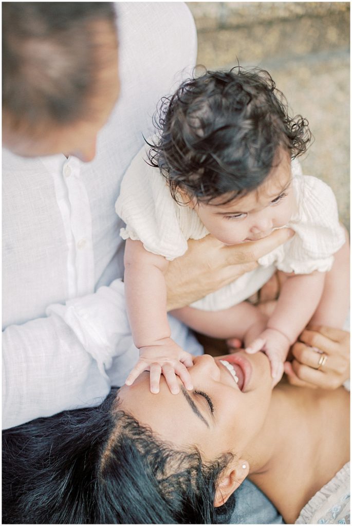 Little Girl Touches Her Mom On The Face During Montgomery County Family Session At Brookside Gardens.