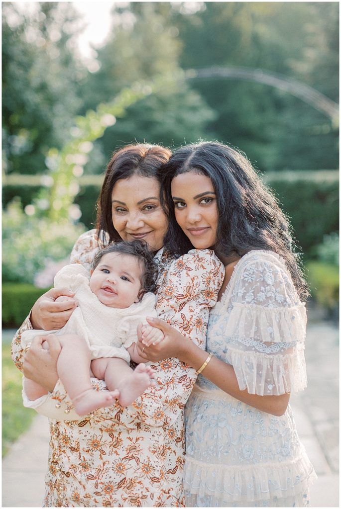 Three Generations Of Women Stand Together During Montgomery County Family Session At Brookside Gardens.