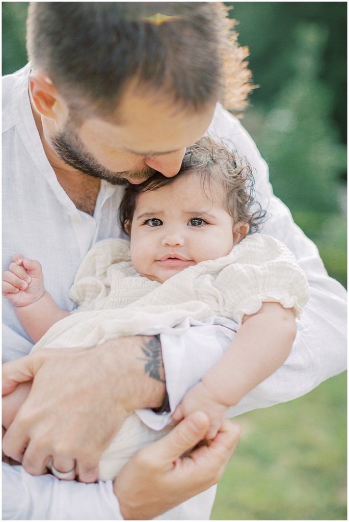 Father Kisses His Infant Daughter On The Head.