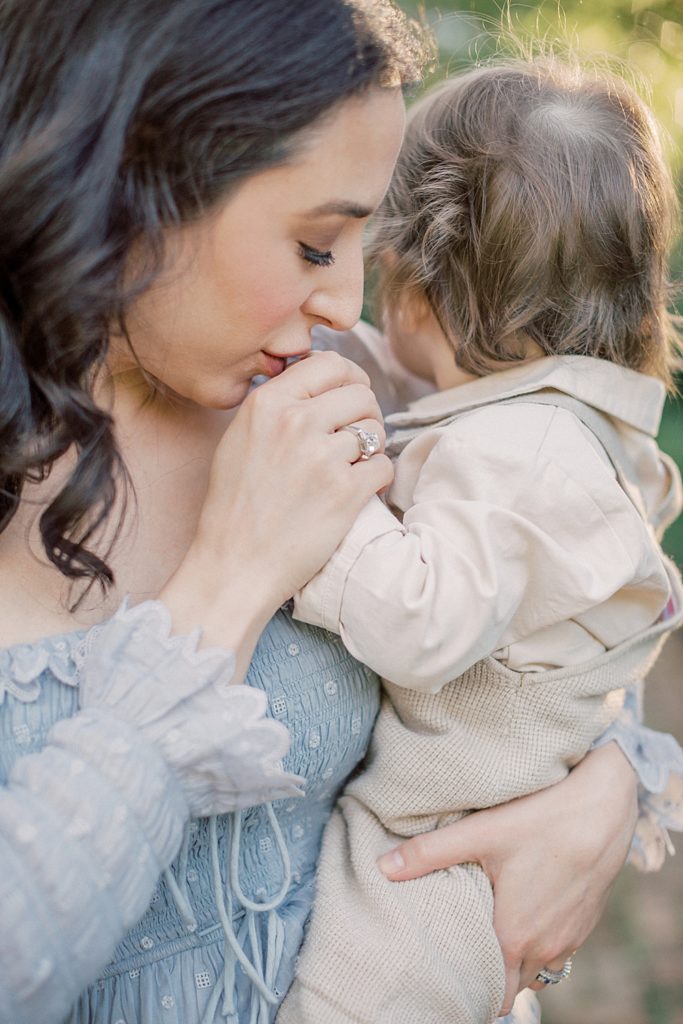 Mother Kisses Her Son's Hand.