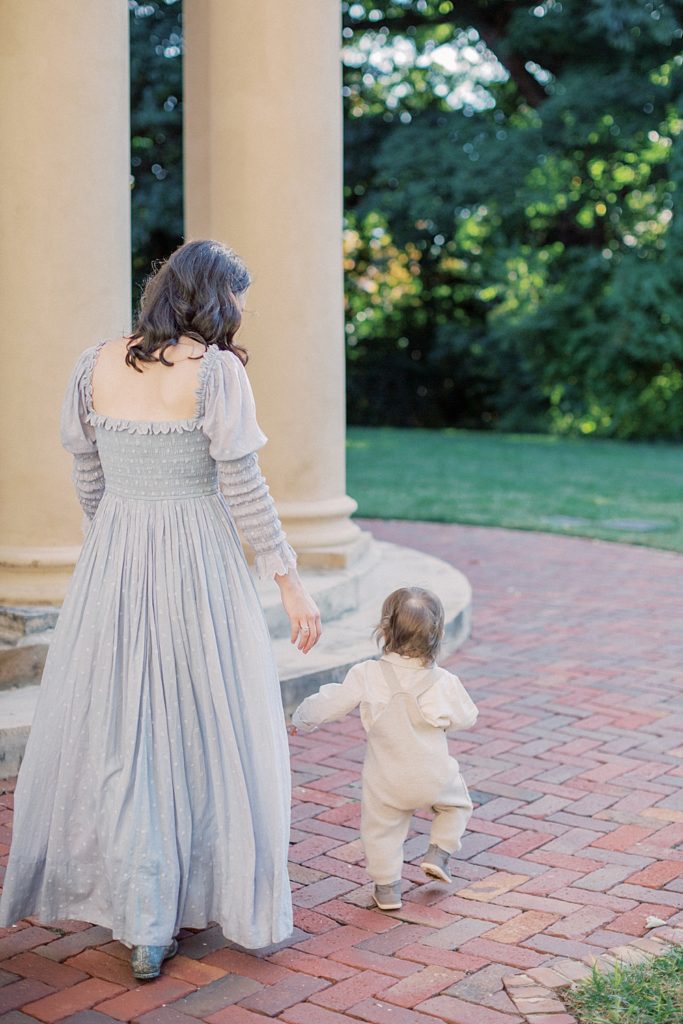 Mother Walks With Toddler Son At Tudor Place Photographed By Georgetown Family Photographer Marie Elizabeth Photography.