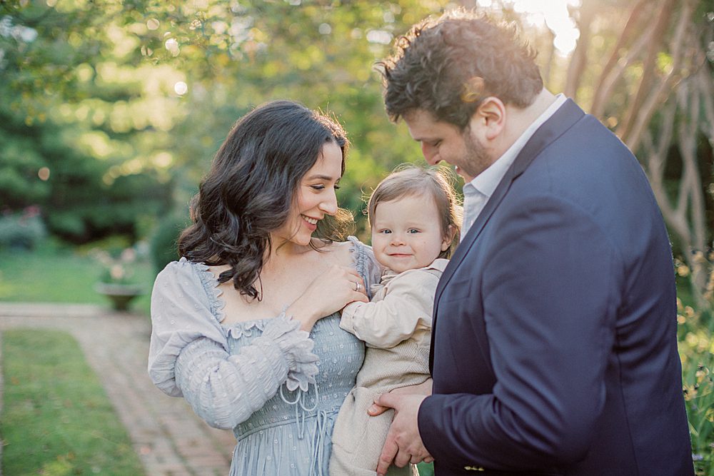 Parents Hold Baby Boy During Family Session At Tudor Place Photographed By Georgetown Family Photographer Marie Elizabeth Photography.