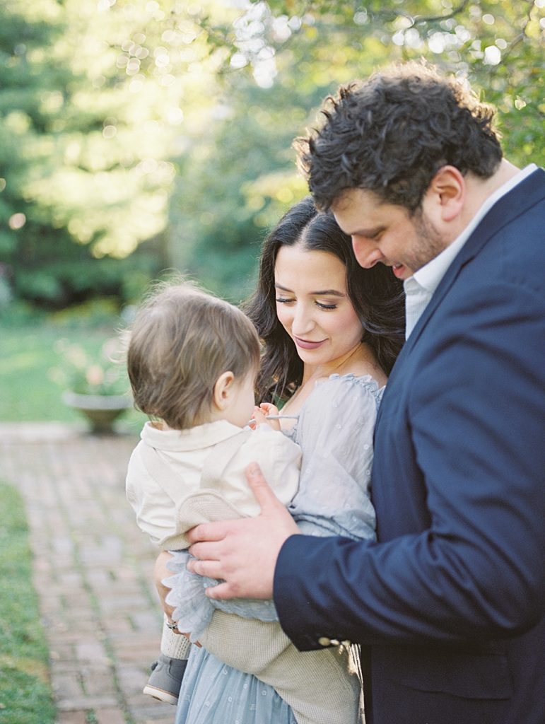 Parents Hold Toddler Son During Family Photos At Tudor Place In Dc.