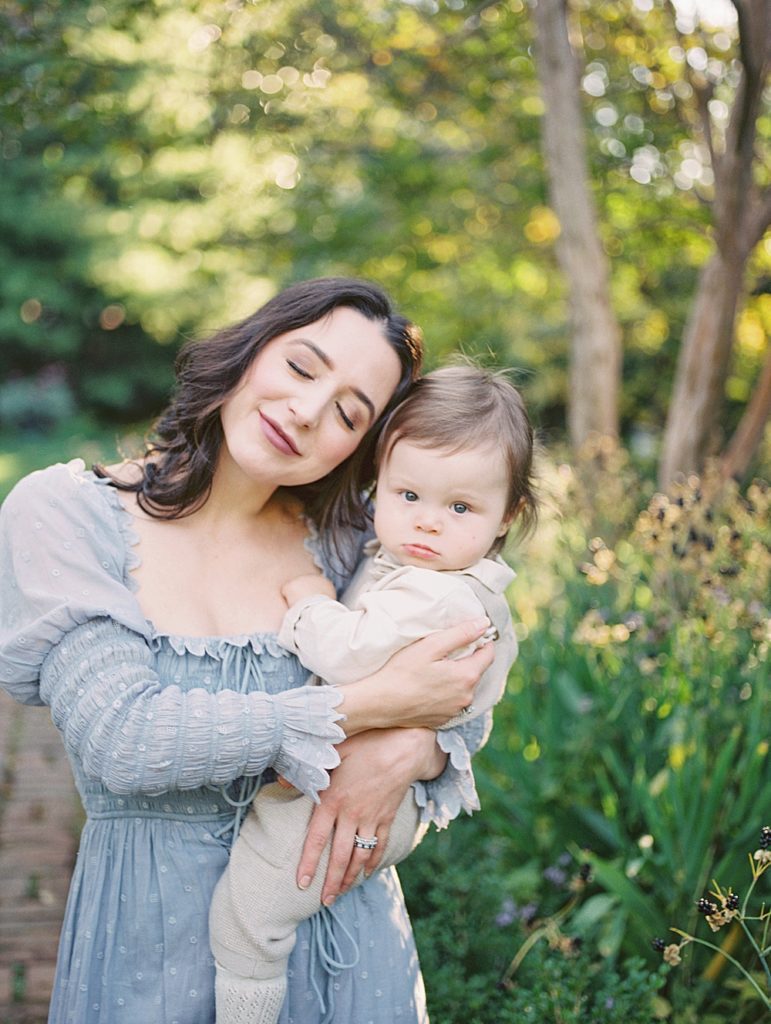 Mother Leans Into Baby Boy And Closes Her Eyes.