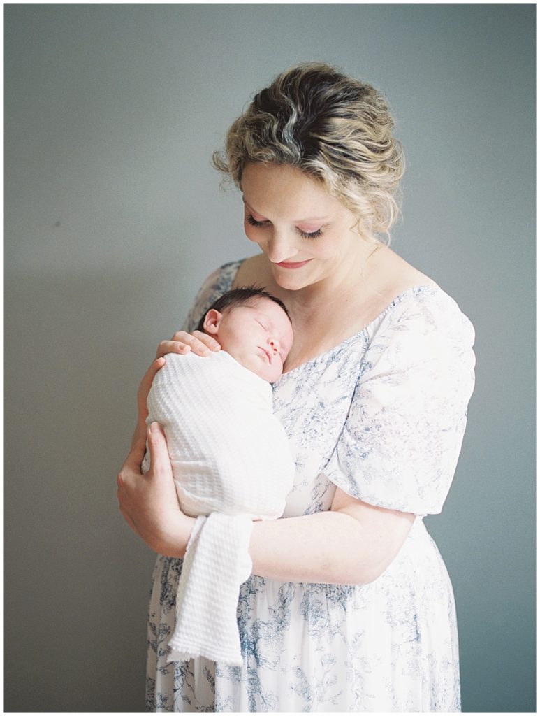 Mother Holds Baby Girl Up On Her Chest During Fairfax Va Newborn Session.