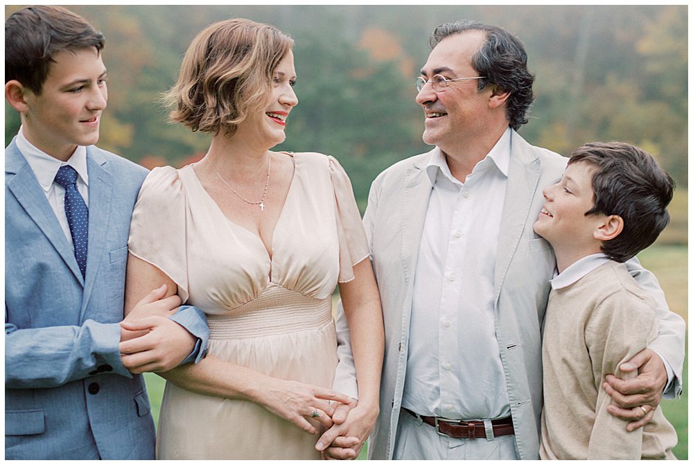 Mother In Gold Dress And Red Lipstick Smiles At Her Husband.